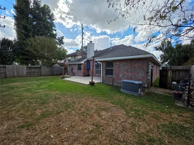 a front view of a house with a garden and trees