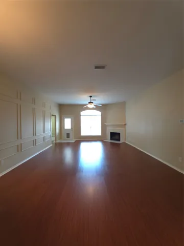 a view of empty room with a fireplace