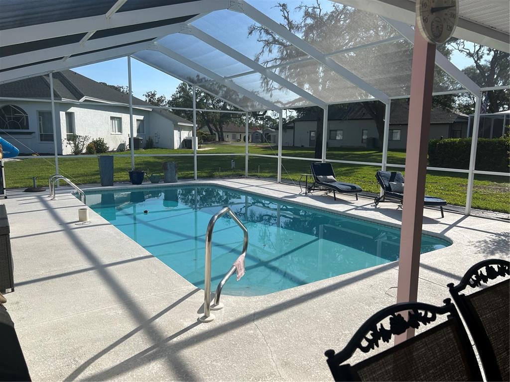 9376 Southern Belle Drive Weeki Wachee, FL 34613 - Photo 6 of 12 a view of a chairs and table in a patio