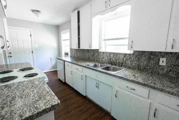 a kitchen with sink stove and refrigerator