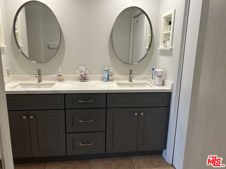 19528 Eagle Ridge Lane Porter Ranch, CA 91326 - Photo 13 of 20 a bathroom with a double vanity sink and a mirror