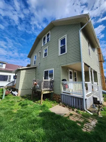 a front view of a house with a yard table and chairs