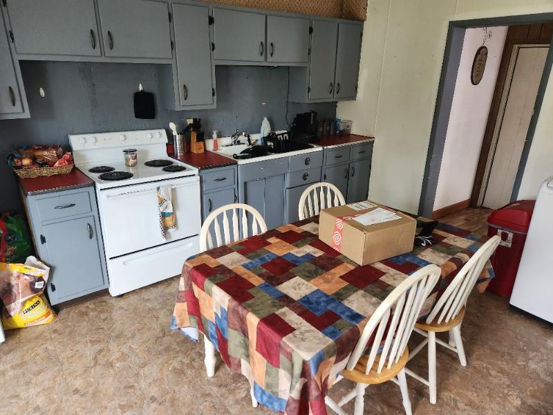 99 Main Street Grampian, PA 16838 - Photo 5 of 14 a kitchen with a stove and white cabinets