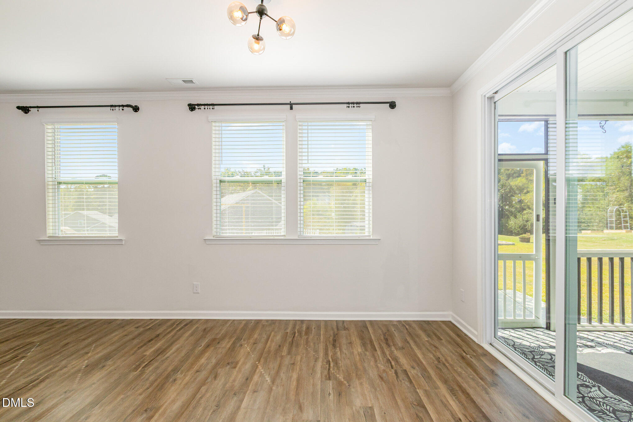 39 Calabor Court Fuquay-Varina, NC 27526 - Photo 10 of 40 a view of an empty room with wooden floor and a window