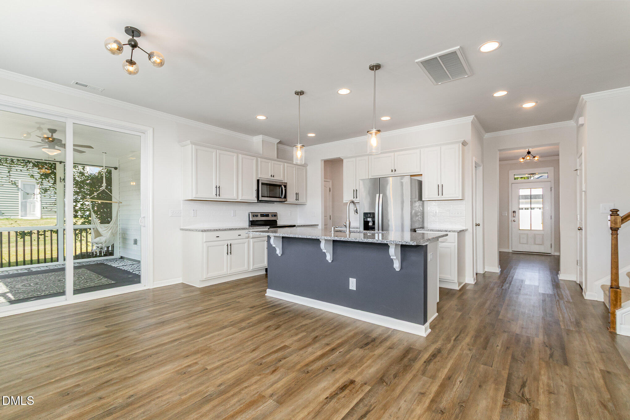 39 Calabor Court Fuquay-Varina, NC 27526 - Photo 13 of 40 a open kitchen with wooden floor and stainless steel appliances