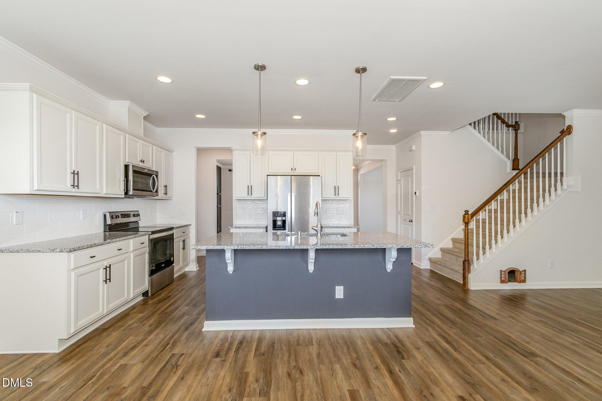39 Calabor Court Fuquay-Varina, NC 27526 - Photo 14 of 40 a view of kitchen with cabinets and wooden floor
