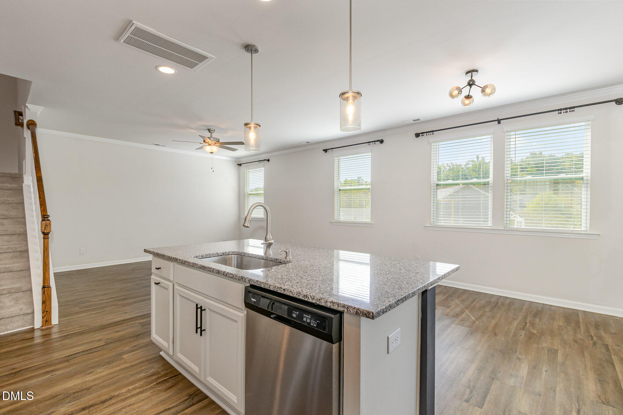 39 Calabor Court Fuquay-Varina, NC 27526 - Photo 17 of 40 a kitchen with a sink chandelier and wooden floor