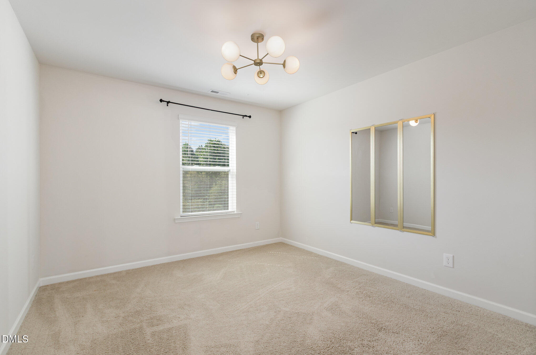 39 Calabor Court Fuquay-Varina, NC 27526 - Photo 18 of 40 an empty room with a window and a fan