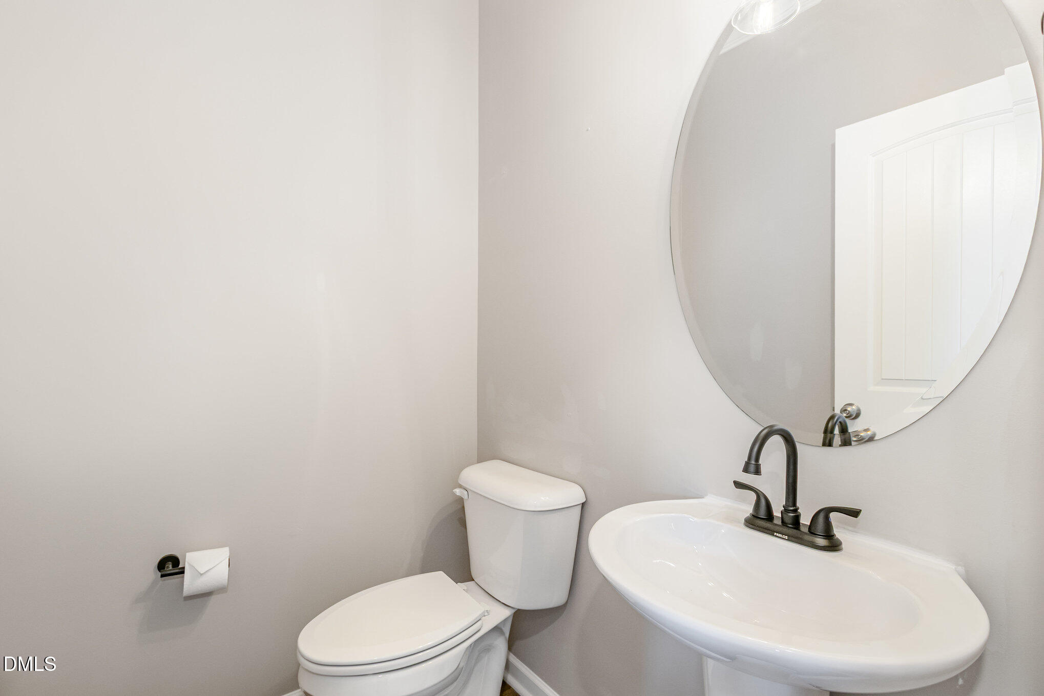 39 Calabor Court Fuquay-Varina, NC 27526 - Photo 19 of 40 a bathroom with a sink a mirror and a toilet