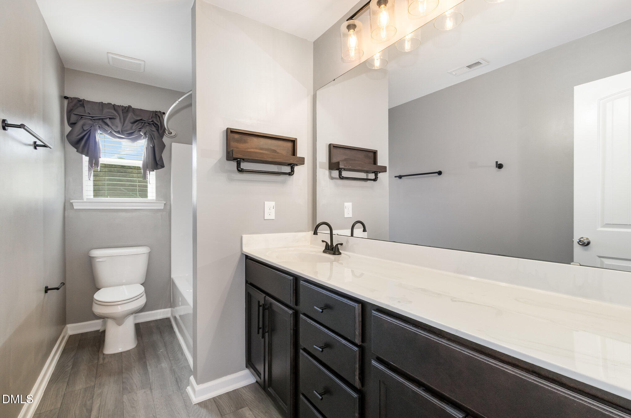 39 Calabor Court Fuquay-Varina, NC 27526 - Photo 23 of 40 a bathroom with a sink a toilet and a mirror