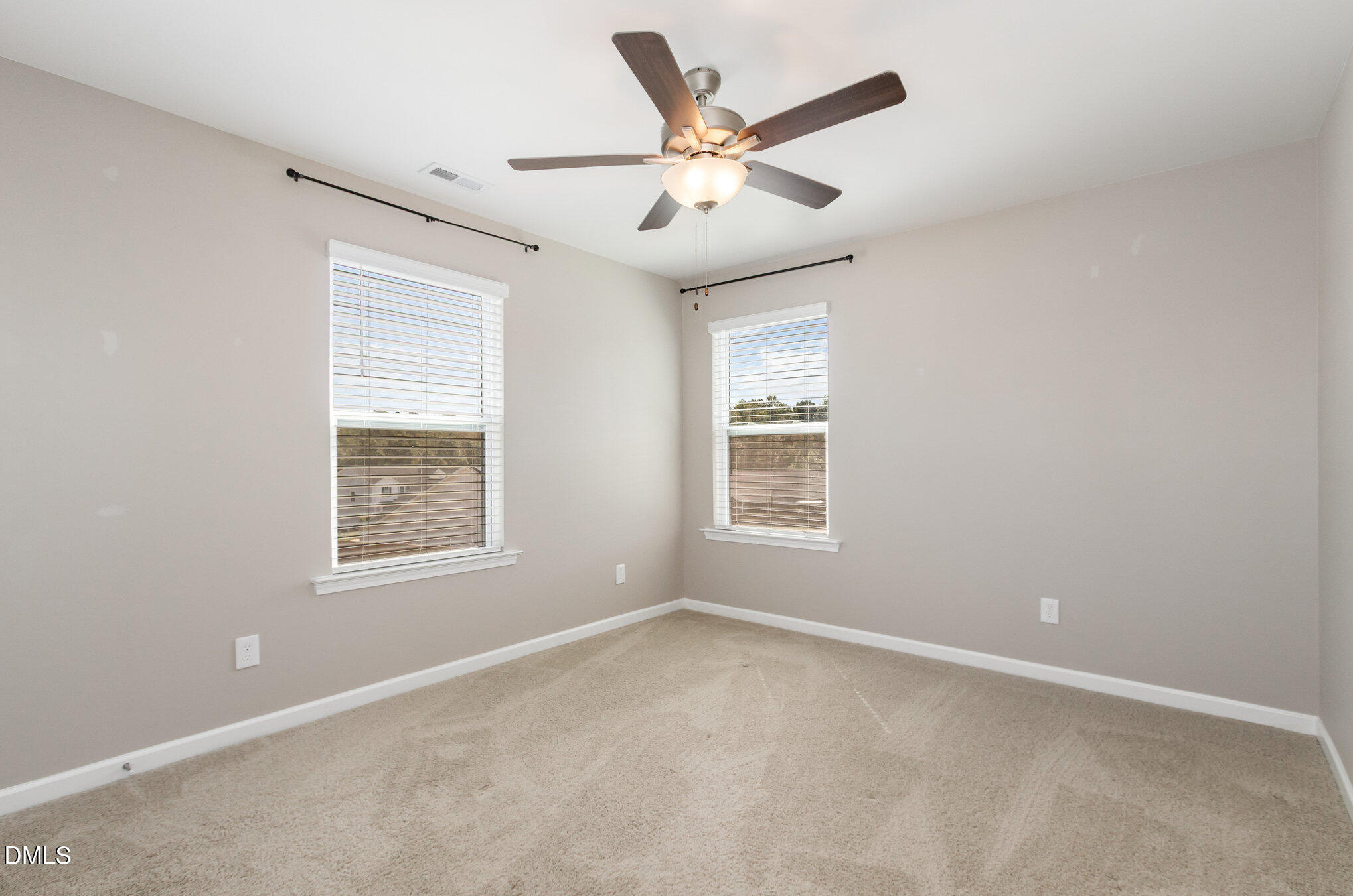 39 Calabor Court Fuquay-Varina, NC 27526 - Photo 24 of 40 an empty room with ceiling fan and windows