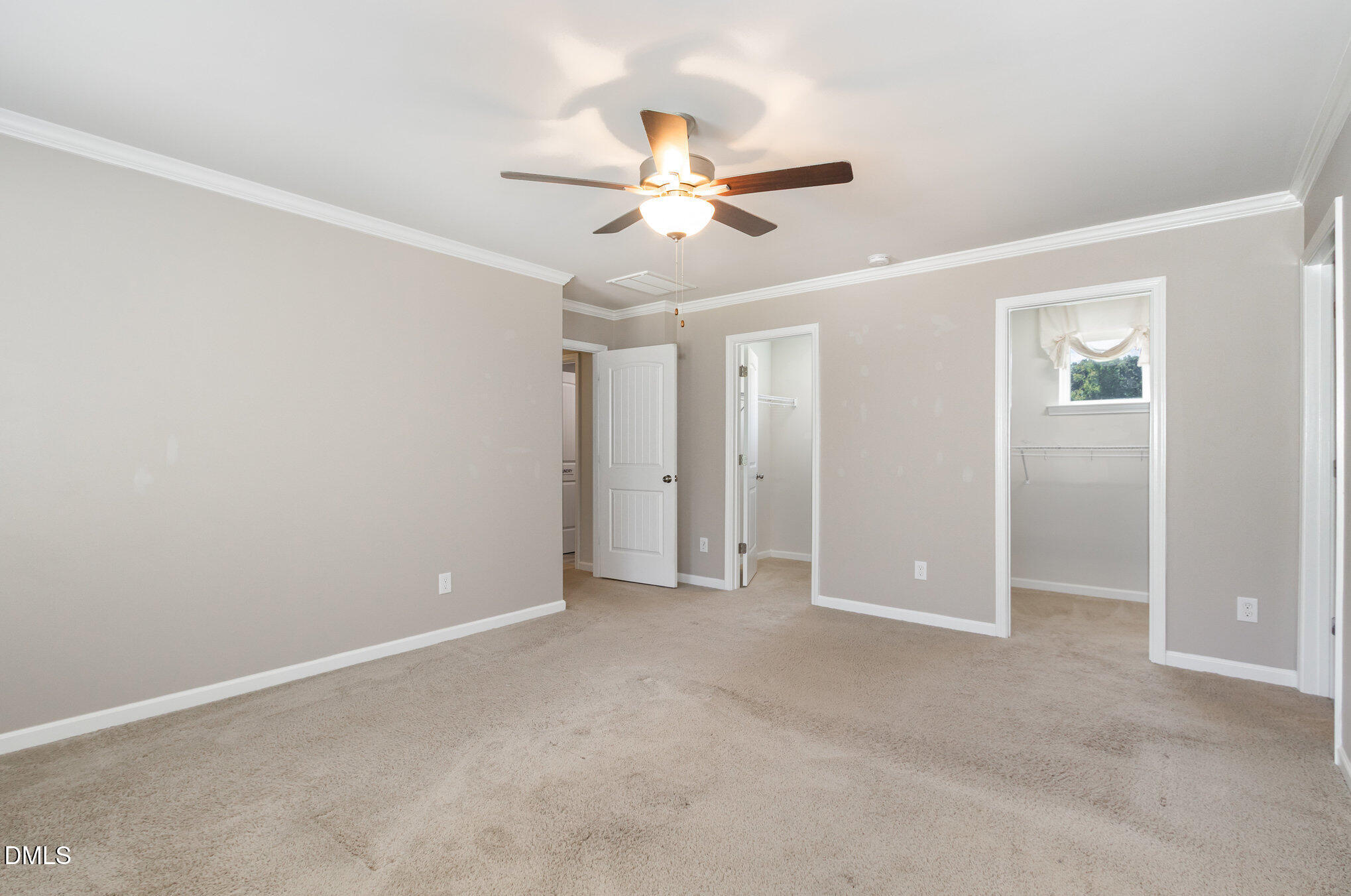 39 Calabor Court Fuquay-Varina, NC 27526 - Photo 27 of 40 an empty room with closet and a ceiling fan