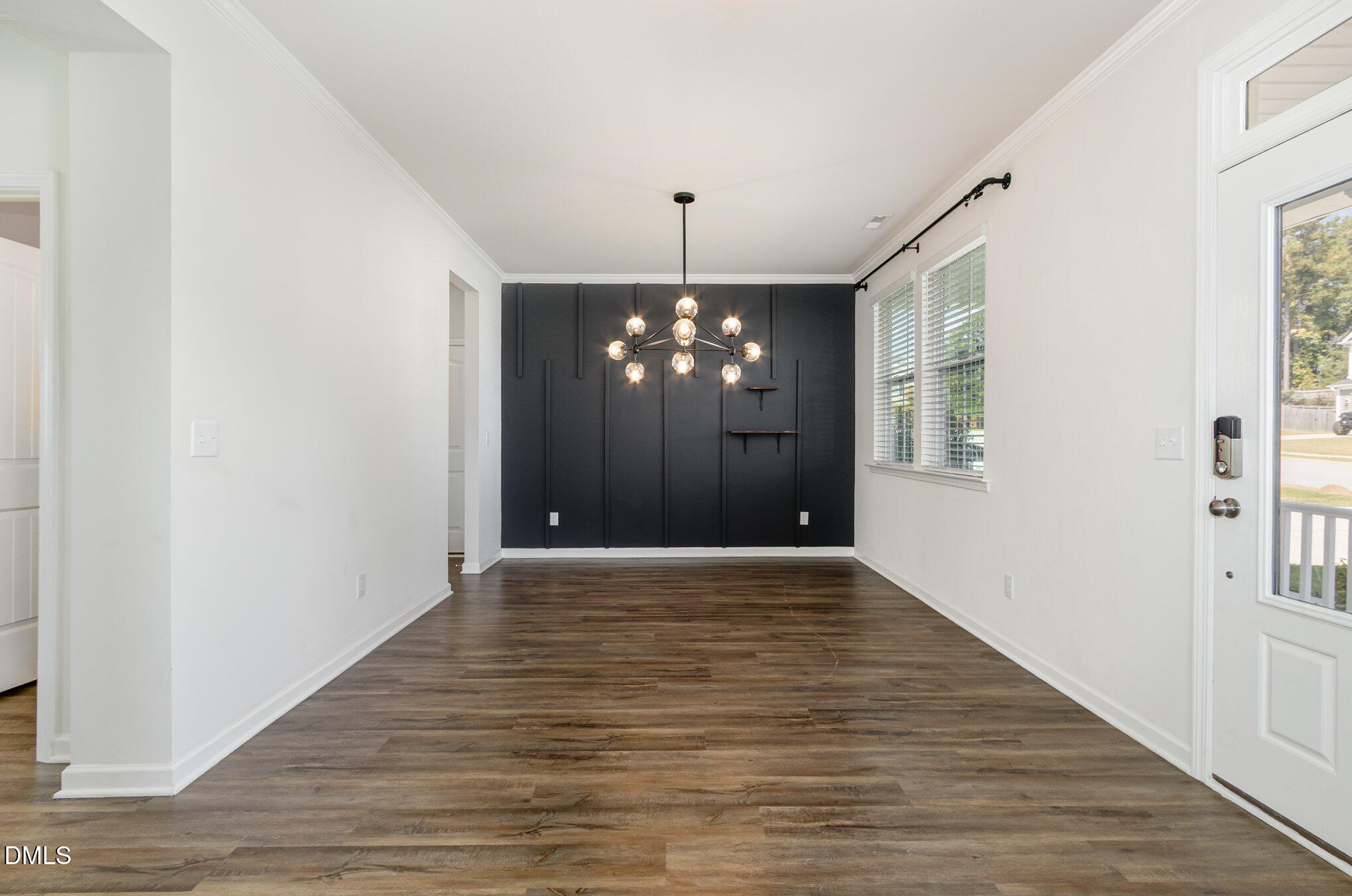 39 Calabor Court Fuquay-Varina, NC 27526 - Photo 7 of 40 a view of an empty room with chandelier and wooden floor