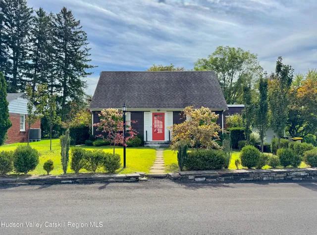 a front view of house with yard and green space