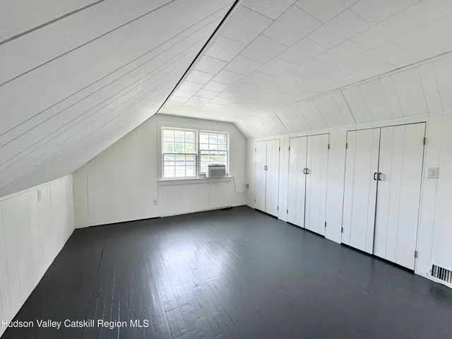 a view of a livingroom with wooden floor and window