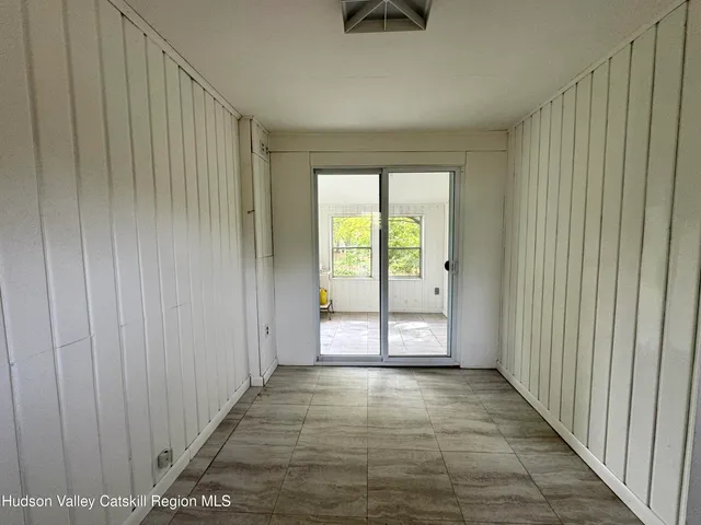 a view of an entryway with wooden floor