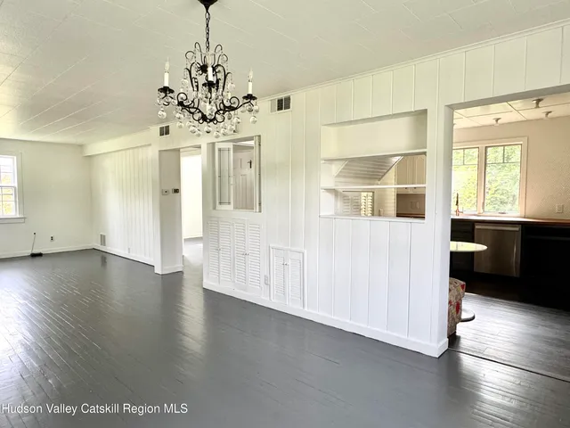 a view of a room with wooden floor and window