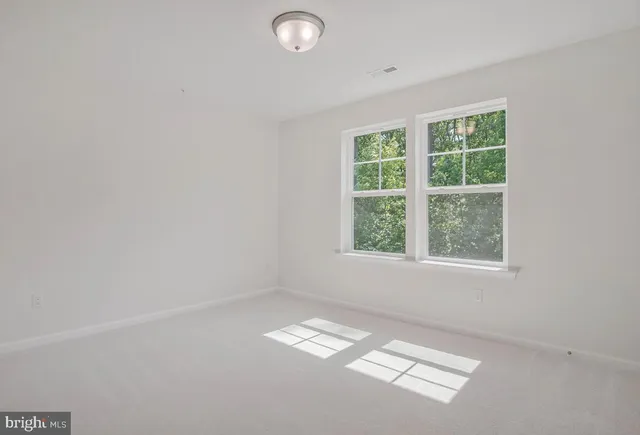 a view of an empty room and a window