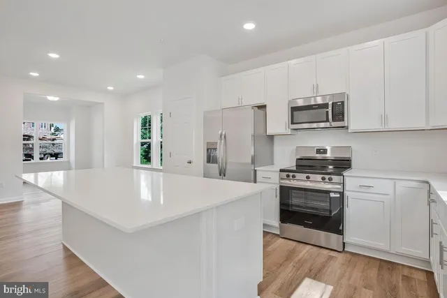 a kitchen with appliances a sink and cabinets