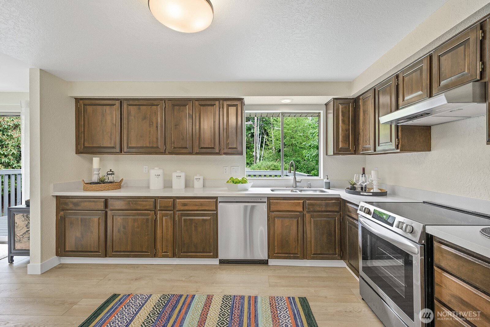 22032 3rd Place West Bothell, WA 98021 - Photo 6 of 20 a kitchen with stainless steel appliances granite countertop a stove a sink dishwasher and cabinets