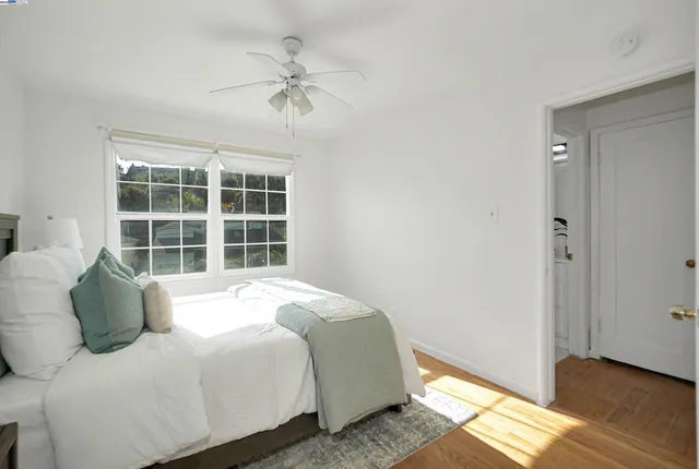 a large bed sitting in a bedroom next to a window