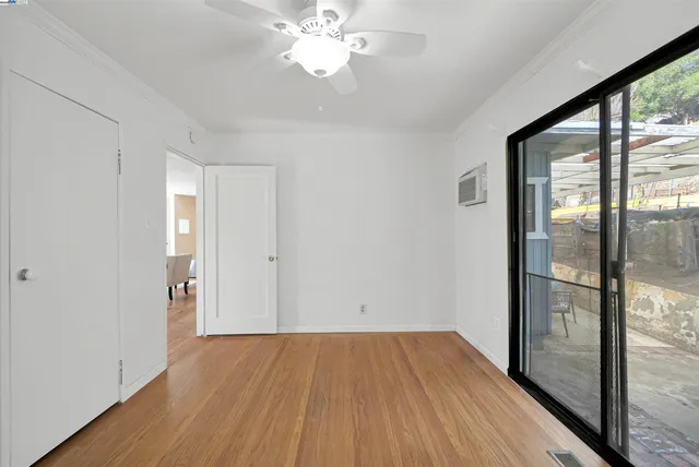 a view of a room with wooden floor and a balcony