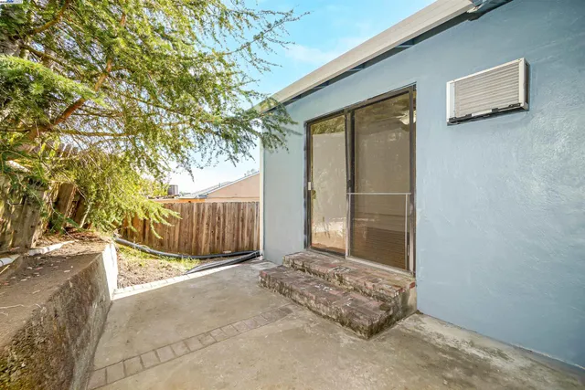 a view of a house with a wooden fence