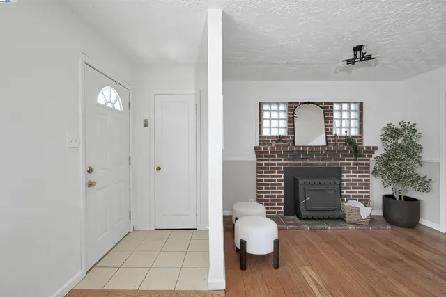 a view of an empty room and fire place