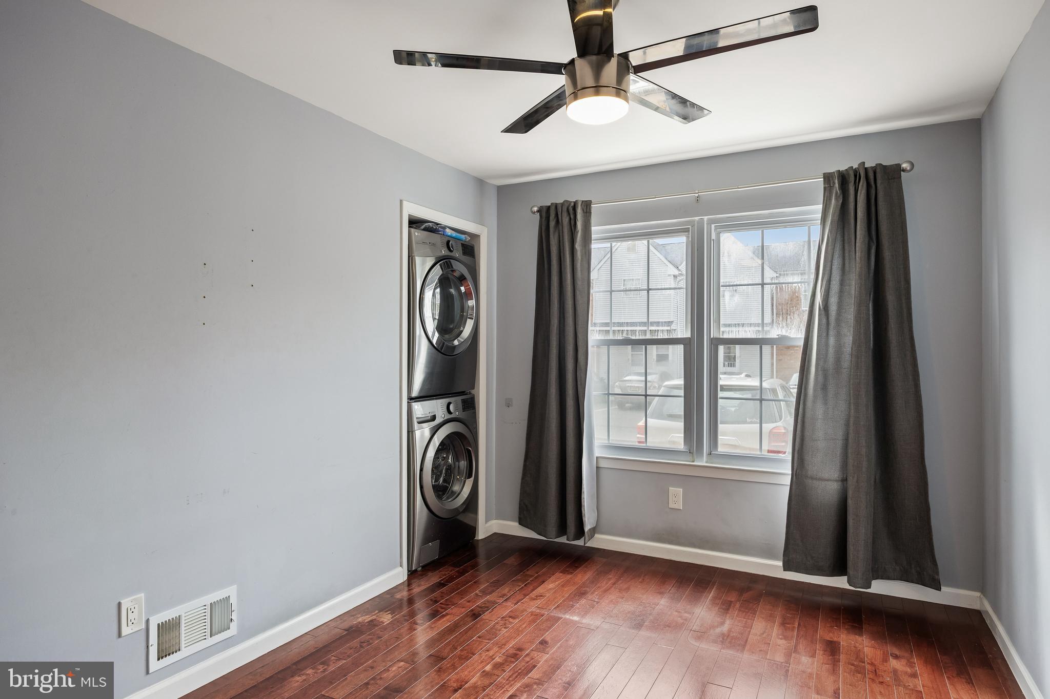 103 Sandstone Court Lumberton, NJ 08048 - Photo 19 of 25 an empty room with wooden floor chandelier fan and windows
