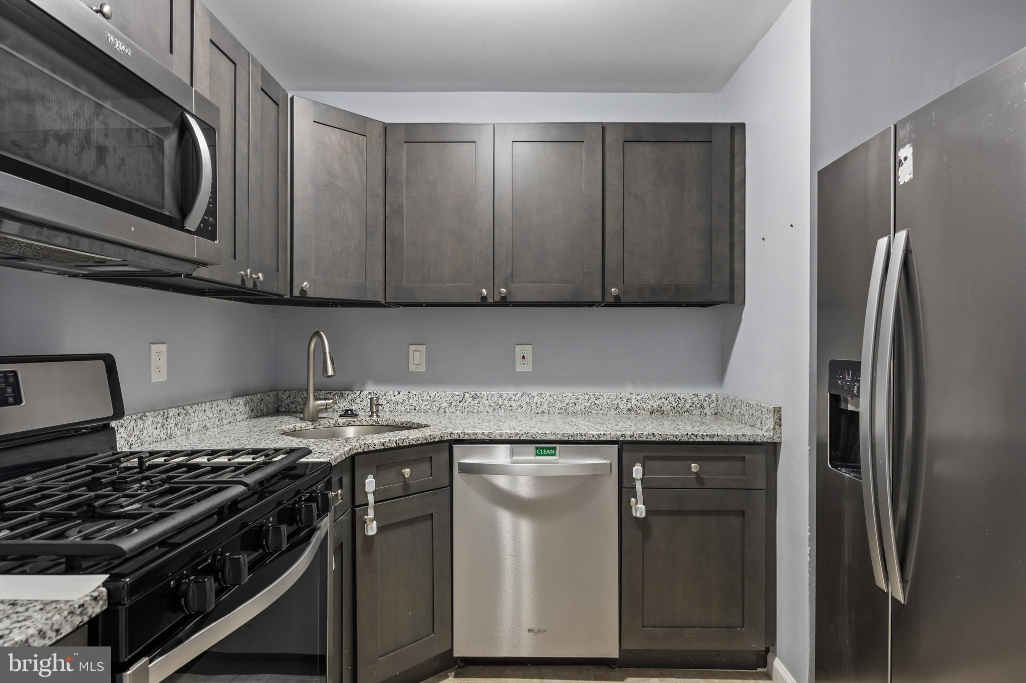 103 Sandstone Court Lumberton, NJ 08048 - Photo 5 of 25 a kitchen with granite countertop a stove sink and cabinets