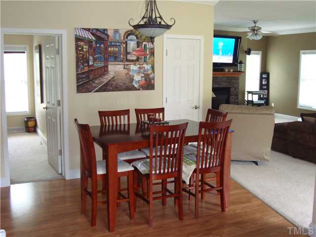 906 Oak Grove Mount Zion Road Roxboro, NC 27574 - Photo 4 of 11 a view of a dining room with furniture and wooden floor