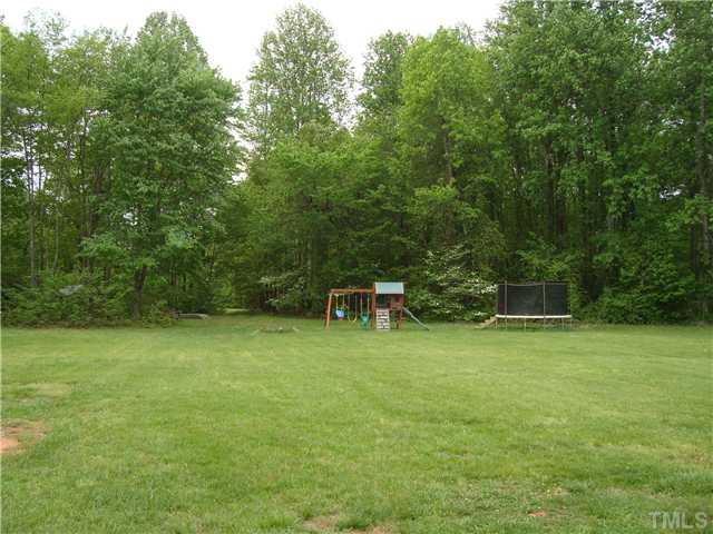 906 Oak Grove Mount Zion Road Roxboro, NC 27574 - Photo 9 of 11 a house with a yard
