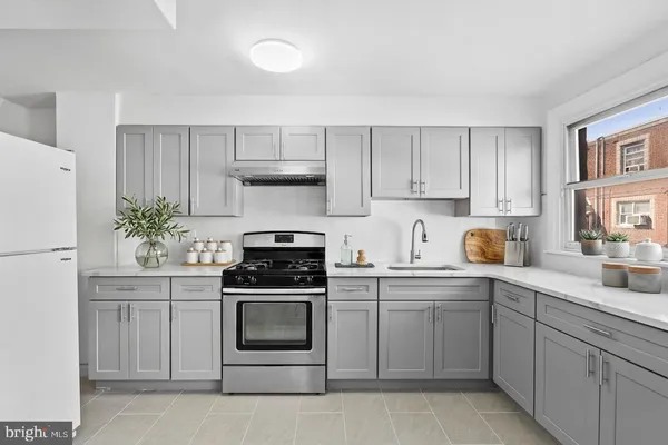 a kitchen with cabinets stainless steel appliances and sink
