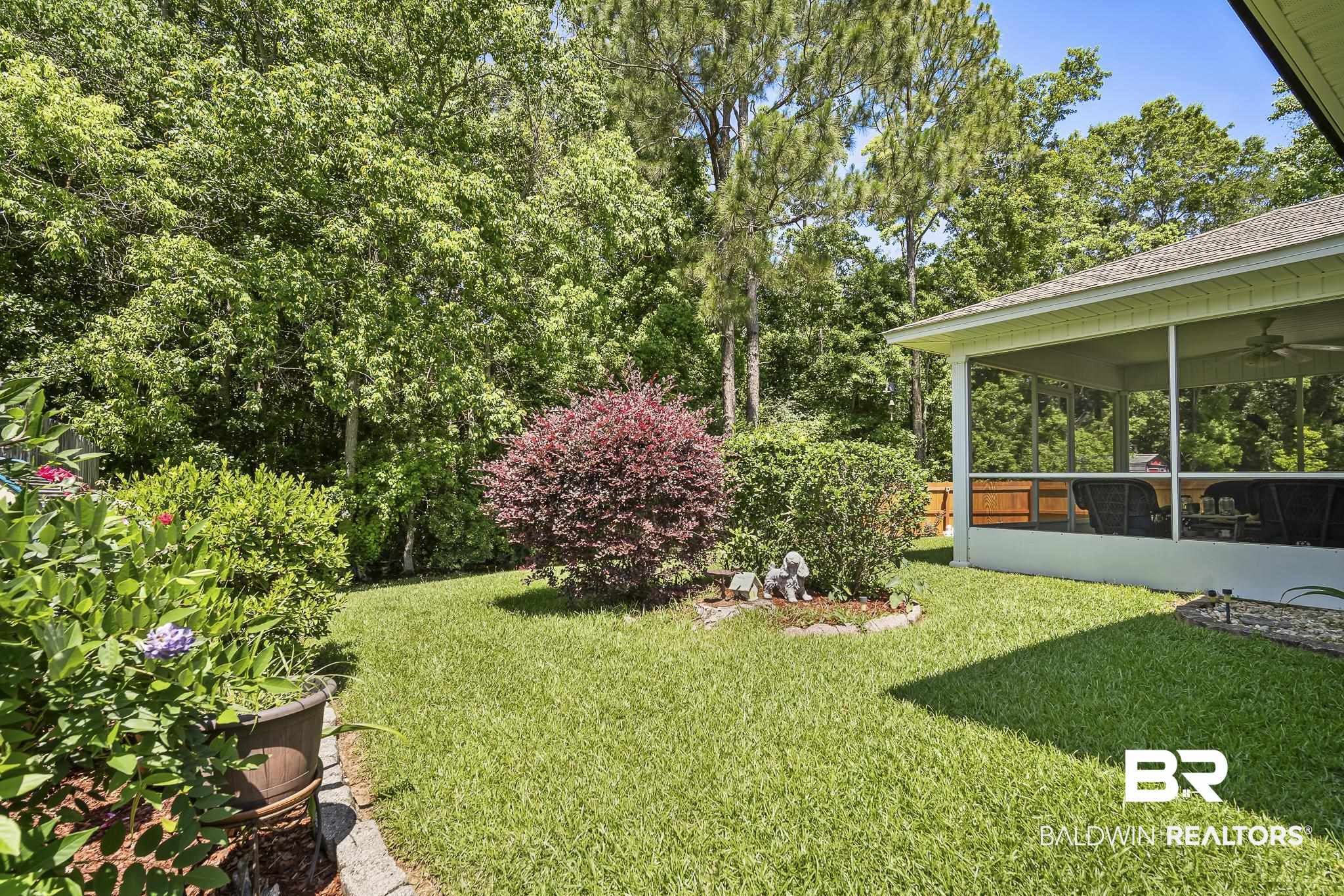 1802 South Bay Street Foley, AL 36535 - Photo 29 of 30 View of green lawn with a sunroom and a ceiling fan