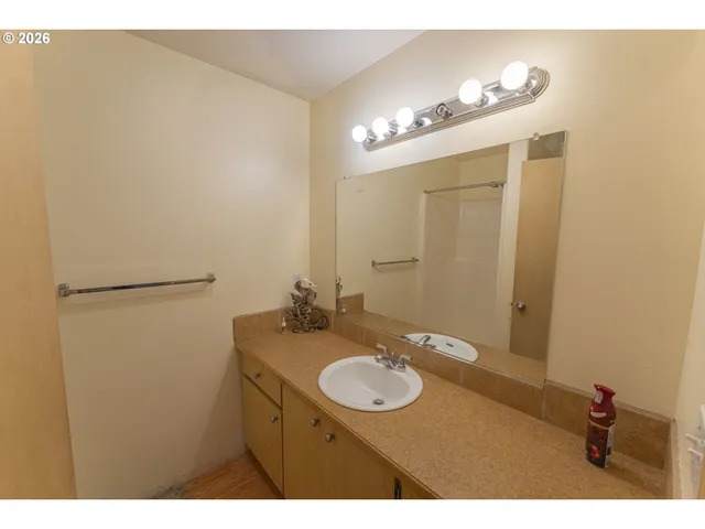 a bathroom with a shower and a sink