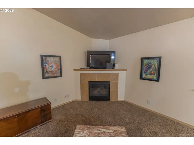 a kitchen with refrigerator and wooden floor
