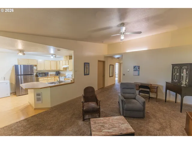 a kitchen with stainless steel appliances kitchen island a refrigerator sink and cabinets