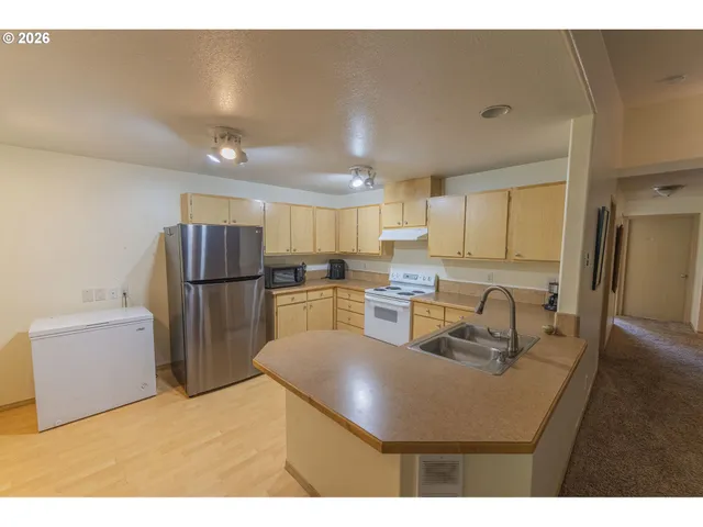 a kitchen with a refrigerator and a sink