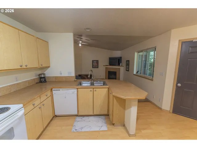 a kitchen with a refrigerator sink and cabinets