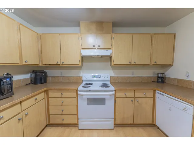 a bedroom with a bed and a refrigerator