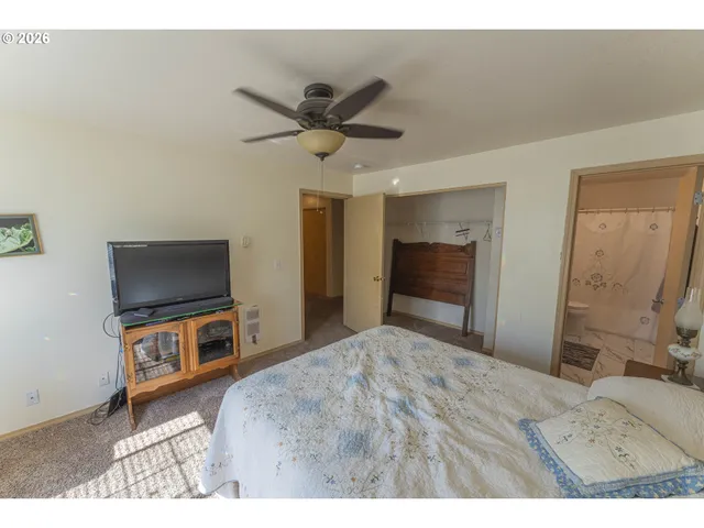 a bathroom with a granite countertop sink toilet a mirror and shower