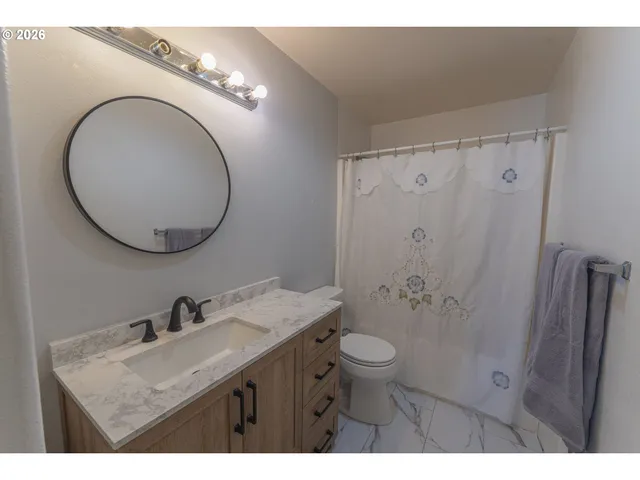 a bathroom with a sink a light fixture and a mirror
