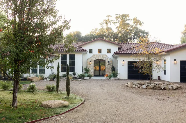 a front view of a house with a yard and garage