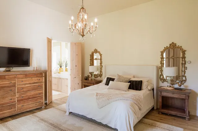 a spacious bathroom with a tub sink and mirror