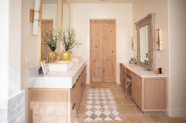 a en suite bathroom with a granite countertop sink and a mirror