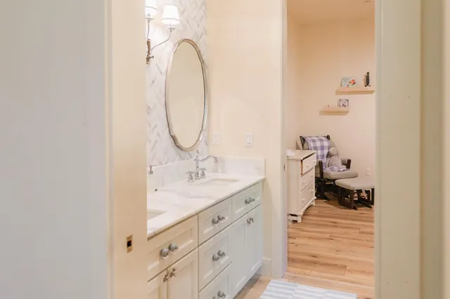 a bathroom with a double vanity sink and a mirror