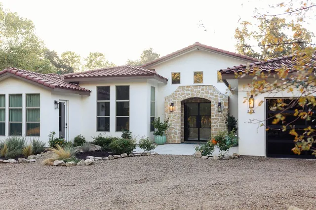 a front view of a house with garden