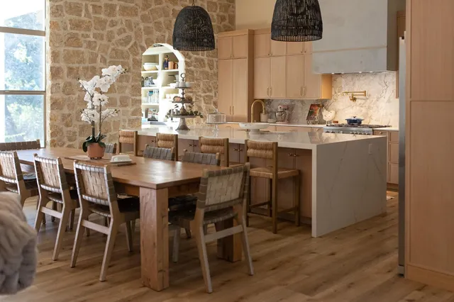 a dining room with chairs and wooden floor