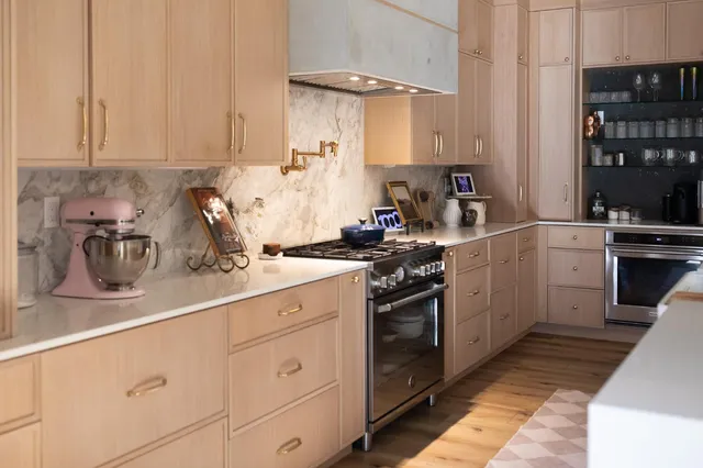 a kitchen with stainless steel appliances granite countertop a sink stove and cabinets