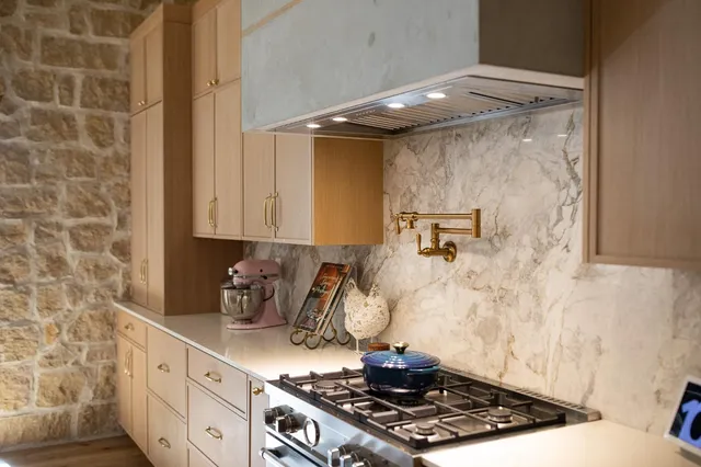 a kitchen with a stove and cabinets